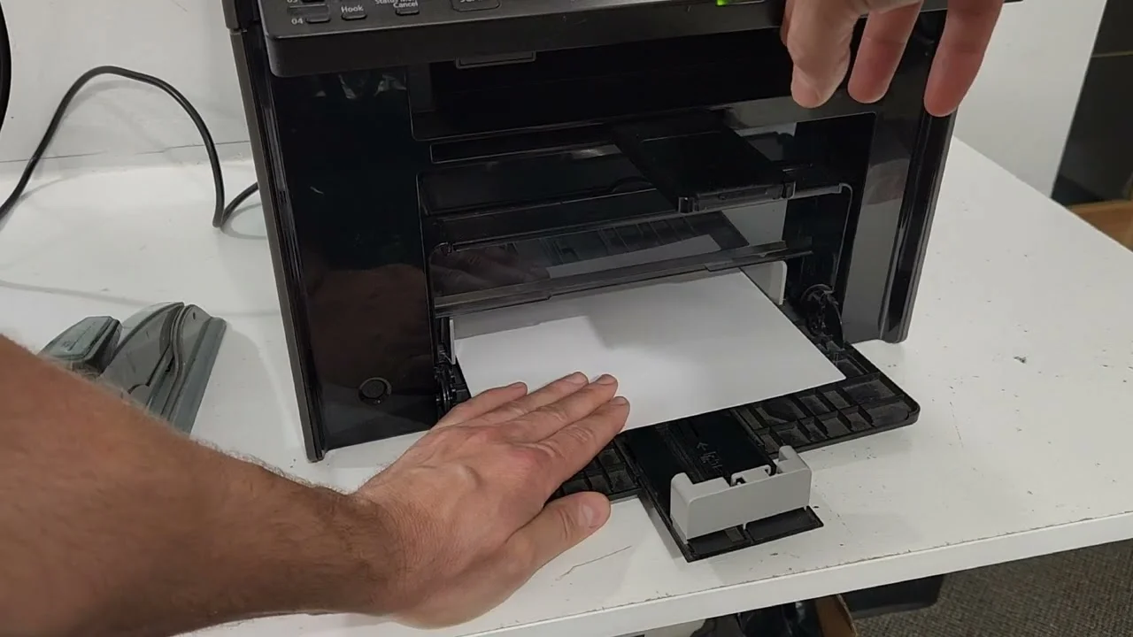 Technician checking paper feed alignment during Printer Maintenance Services.